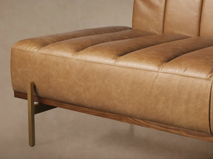 Lansing Leather Daybed, light brown channel-tufted leather, low back, long seat, supported by slim gold metal legs.