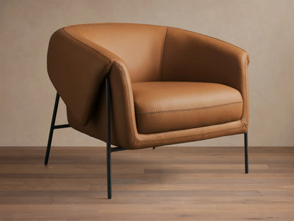 Front view of a Caramel Linus Leather Chair with a curved back, prominent stitching, and sleek black metal legs.