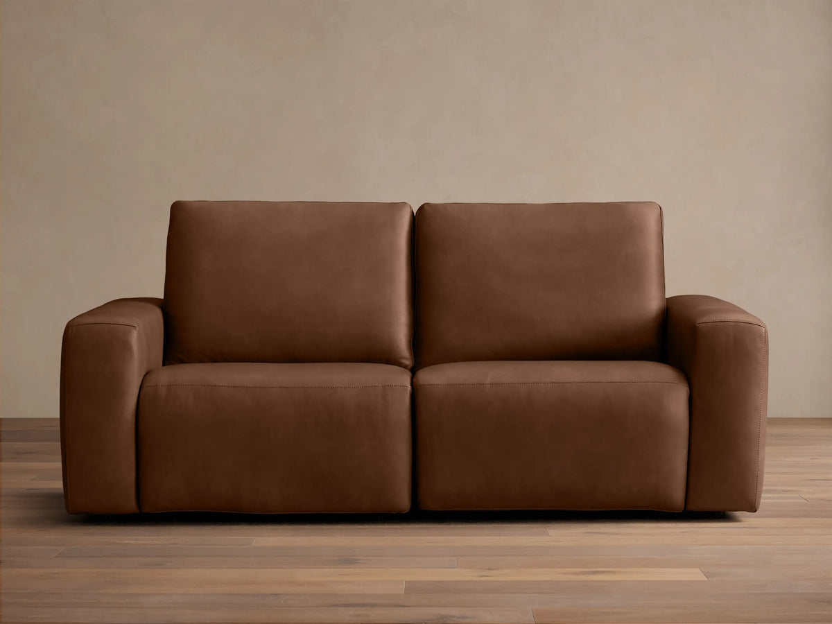 Front view of a brown Brennan Leather Two-Piece Motion Sofa™ with two seats, plush back and seat cushions, and wide block arms.