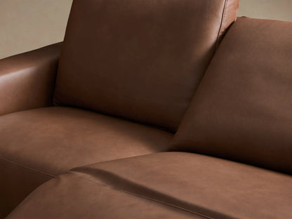 Front view of the brown Brennan Leather Two-Piece Motion Sofa, featuring two distinct reclining seats and wide armrests.