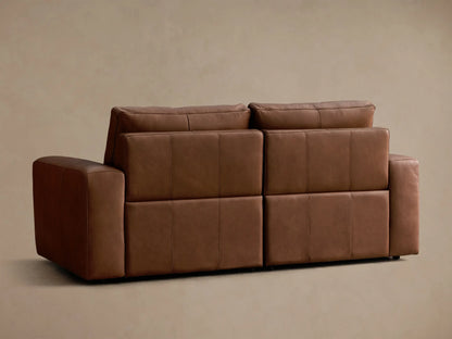 Close-up of the brown Brennan Leather Two-Piece Motion Sofa, highlighting its smooth leather texture and stitching details.