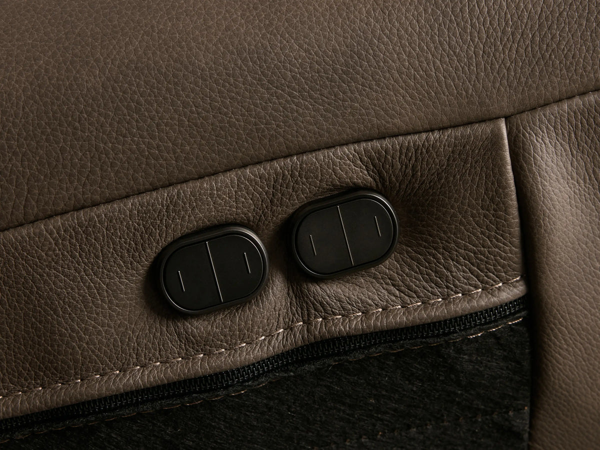Front view of the brown Brennan Leather Two-Piece Motion Sofa with wide armrests and visible stitching on the cushions.
