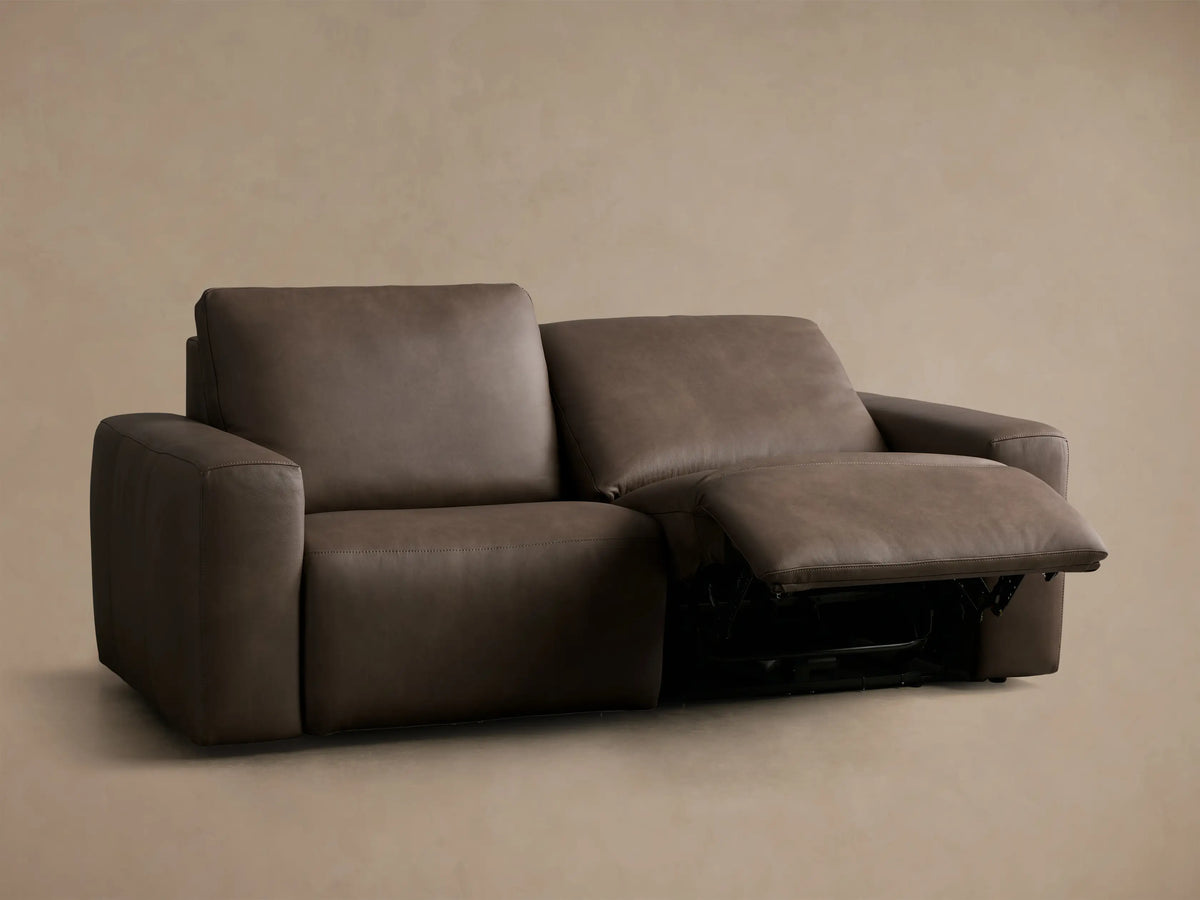Rear view of the dark brown Brennan Leather Two-Piece Motion Sofa with visible seams and two-cushion back design.