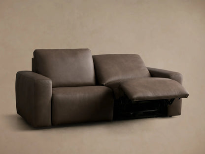 Rear view of the dark brown Brennan Leather Two-Piece Motion Sofa with visible seams and two-cushion back design.