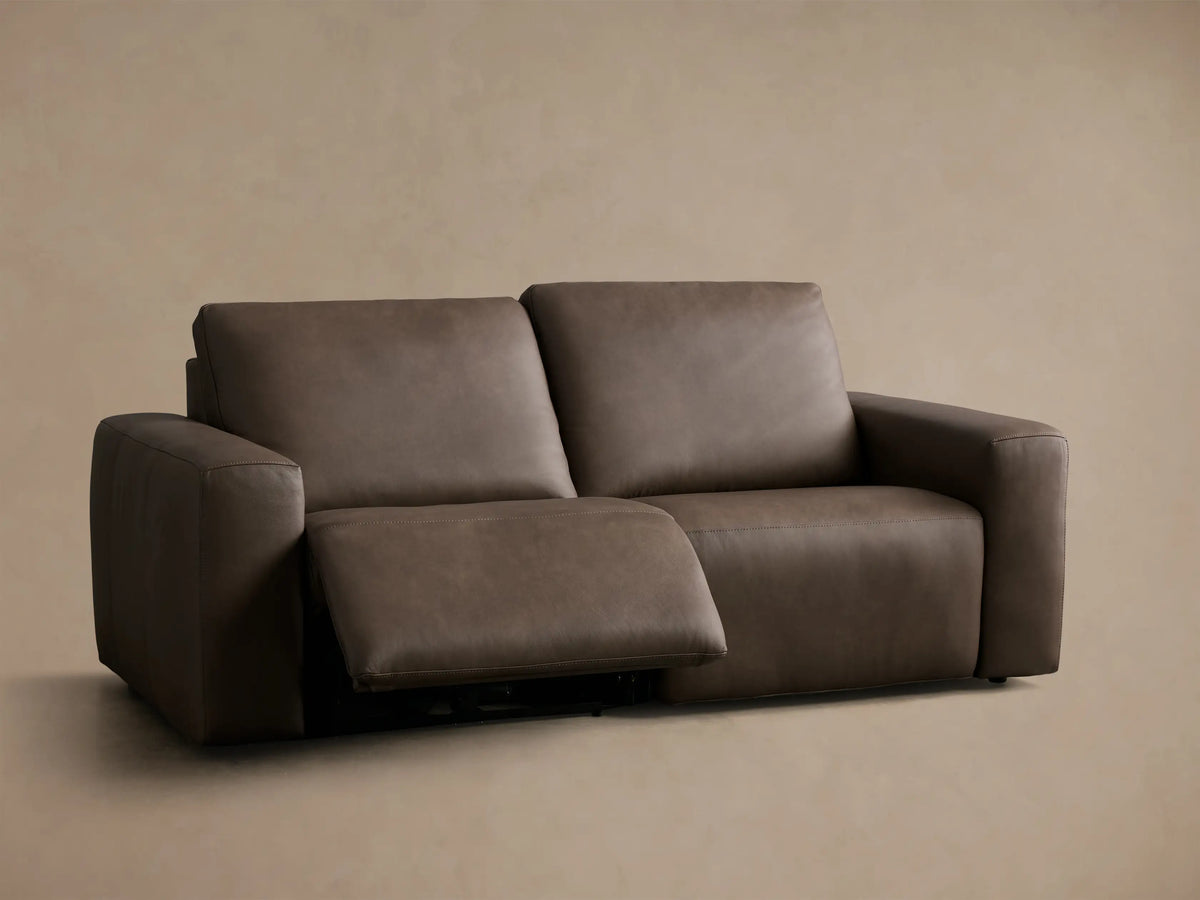 Front view of a dark brown Brennan Leather Two-Piece Motion Sofa with the right recliner extended.