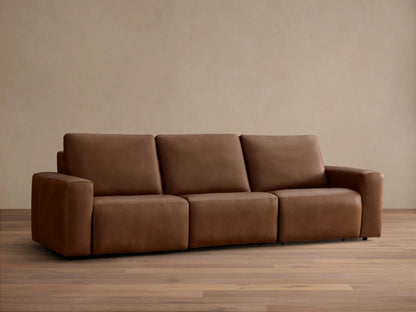 Front view of the brown Brennan Leather Three-Piece Motion Sofa, displaying its integrated design with wide arms and plush seats.