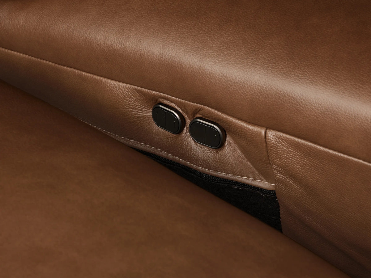 Front view of the Brown Brennan Leather Three-Piece Motion Sofa with smooth leather upholstery and three separate reclining sections.