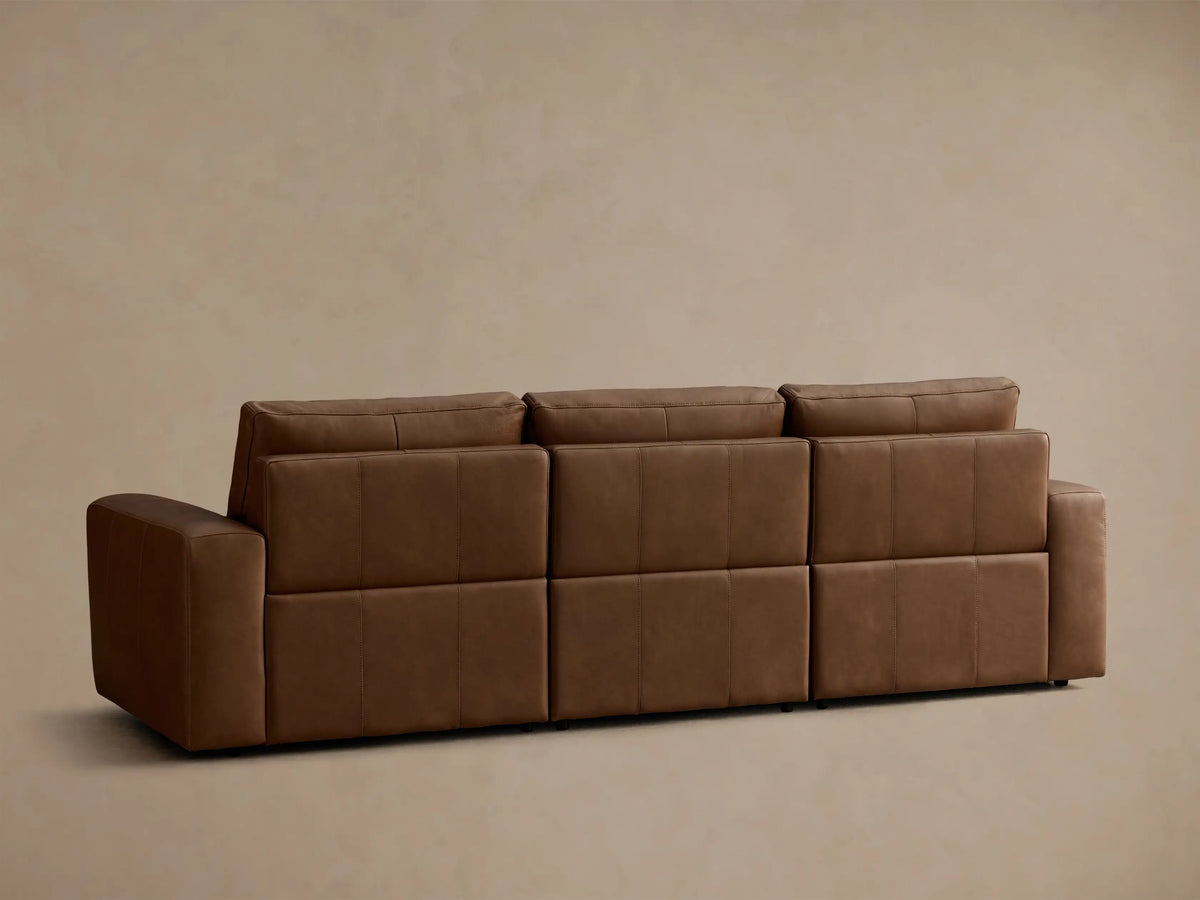 Close-up of the brown leather on the Brennan Leather Three-Piece Motion Sofa, highlighting the texture and cushion stitching.