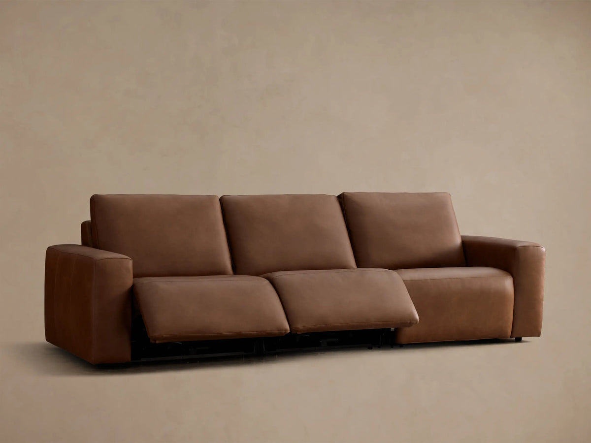 Rear view of the brown leather Brennan Leather Three-Piece Motion Sofa™.