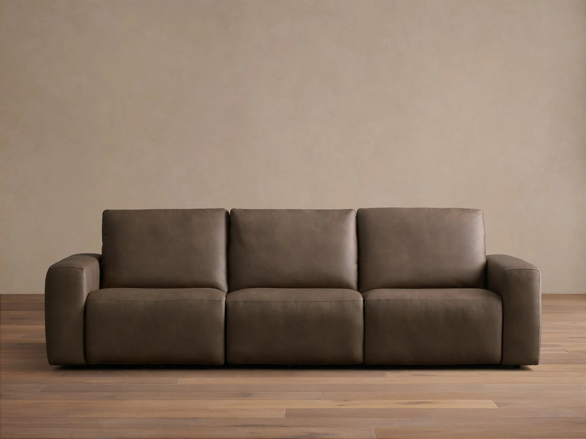 Front view of the brown leather Brennan Leather Three-Piece Motion Sofa, featuring three seats and wide squared arms.