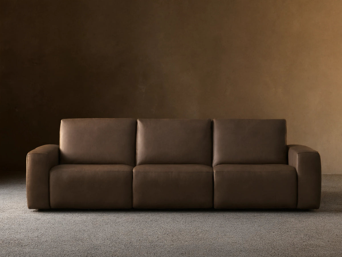 Front view of the brown leather Brennan Leather Three-Piece Motion Sofa, featuring three seats and wide squared arms.