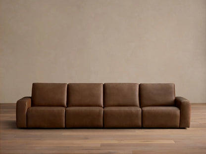 Front view of the brown Brennan Leather Four-Piece Motion Sectional with four plush sections.