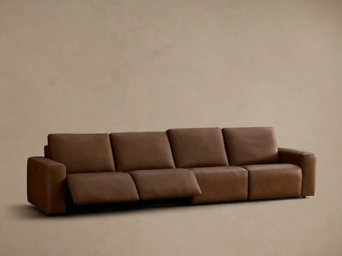 Front view of the brown Brennan Leather Four-Piece Motion Sectional with two right recliners extended.