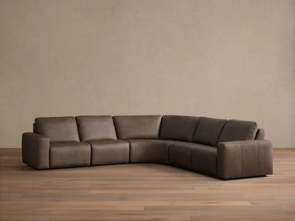 Front view of the brown Brennan Leather Five-Piece Motion Corner Sectional, an L-shaped sofa with smooth cushions.