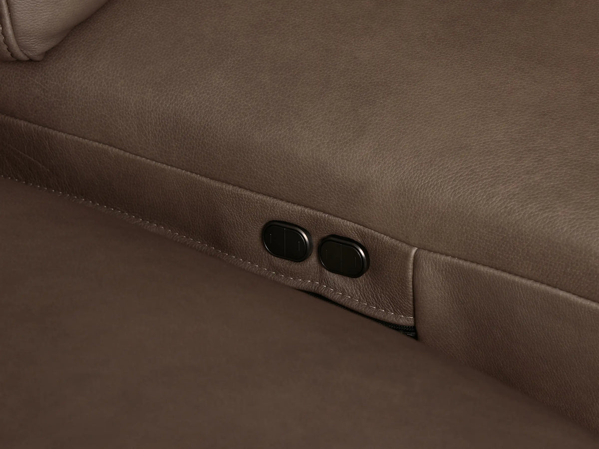 Brown Brennan Leather Five-Piece Motion Corner Sectional, L-shaped, on a light wood floor against a neutral wall.