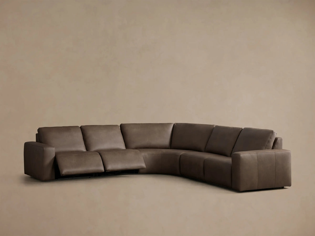 Front view of a brown Brennan Leather Five-Piece Motion Corner Sectional, with the right arm recliner extended.