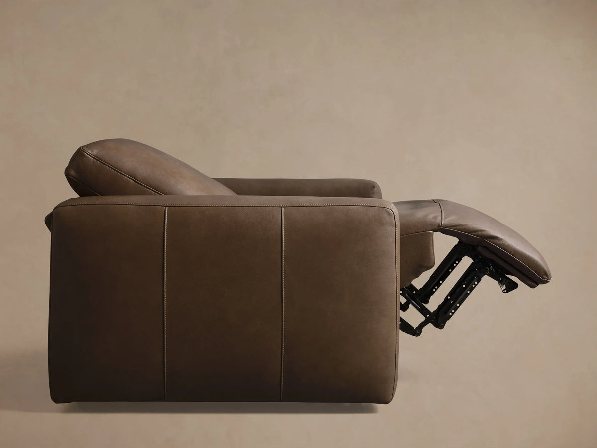Front view of the brown Brennan Leather Motion Recliner, featuring smooth leather upholstery and stitched seams.