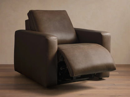 Side profile of the brown leather Brennan Leather Motion Recliner, partially reclined with the footrest extended.