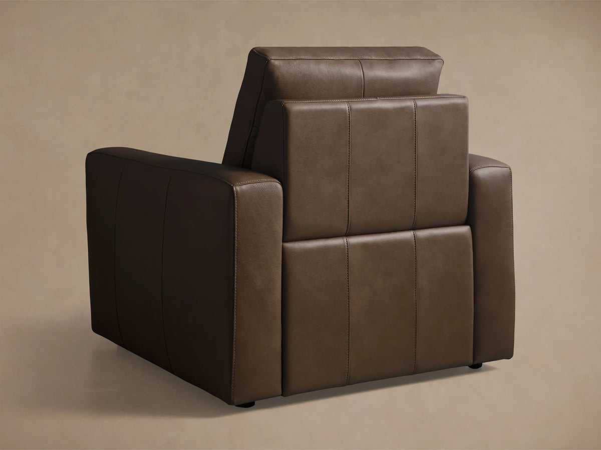 Front view of the brown leather Brennan Leather Motion Recliner, showcasing its sleek, modern design with visible stitching.