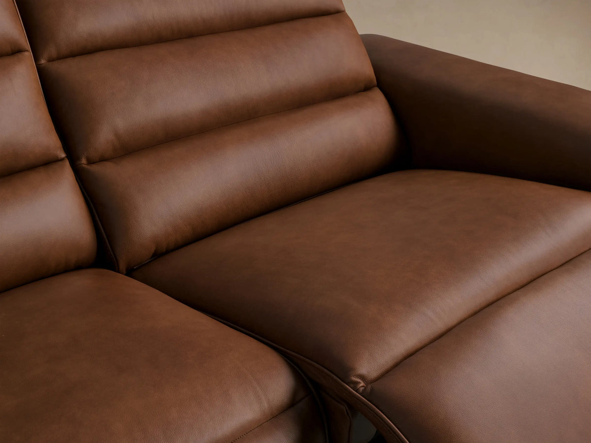Borough Leather Two-Piece Motion Sofa in rich brown leather, modern design, two seats with horizontal tufting, on a wood floor.