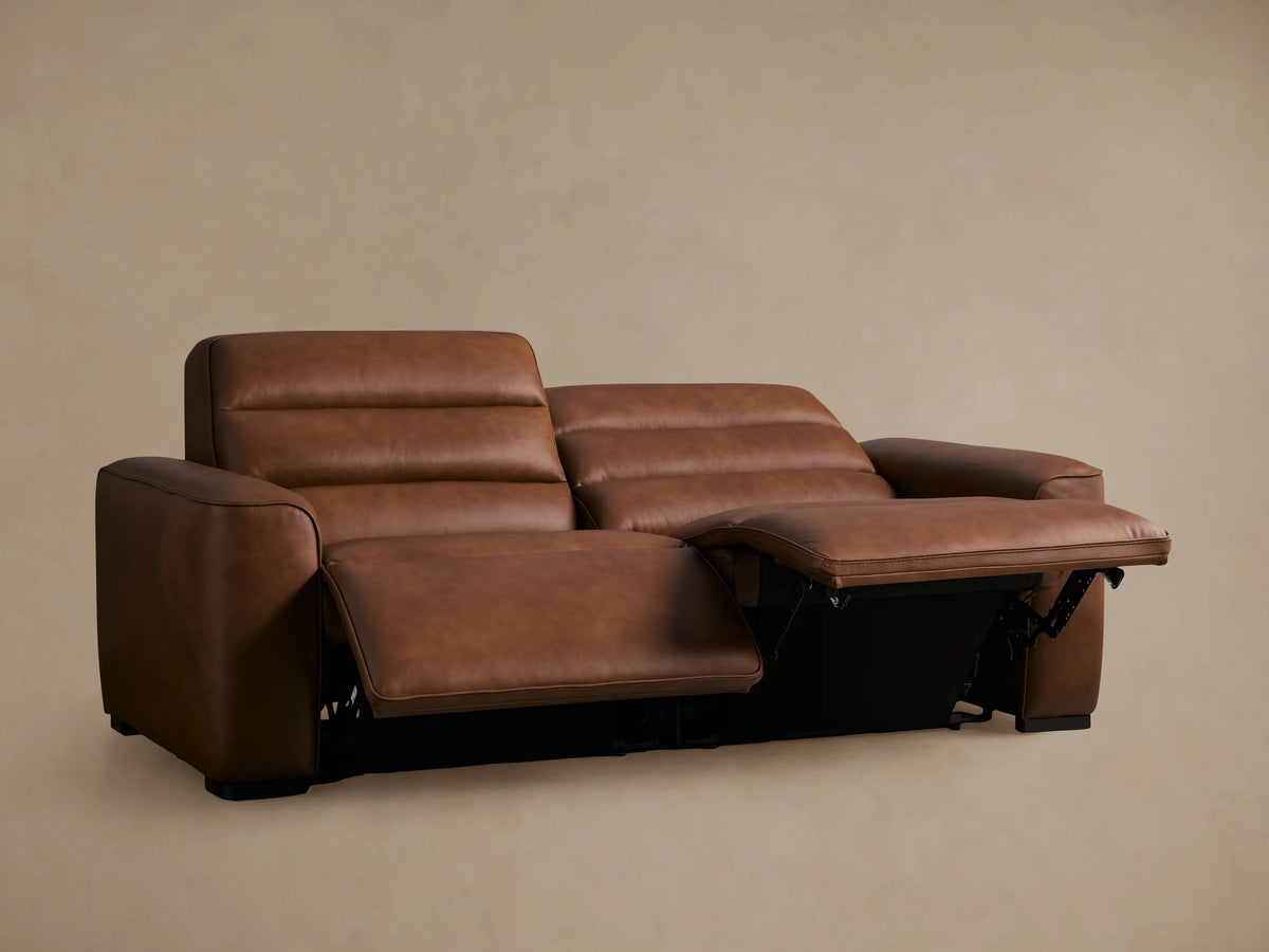 Close-up of Borough Leather Two-Piece Motion Sofa, rich brown, with horizontally tufted back and extended footrest.