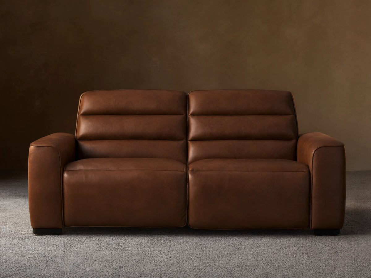 Front view of Borough Leather Two-Piece Motion Sofa, rich warm brown leather, modern design with two seats, horizontally tufted back.