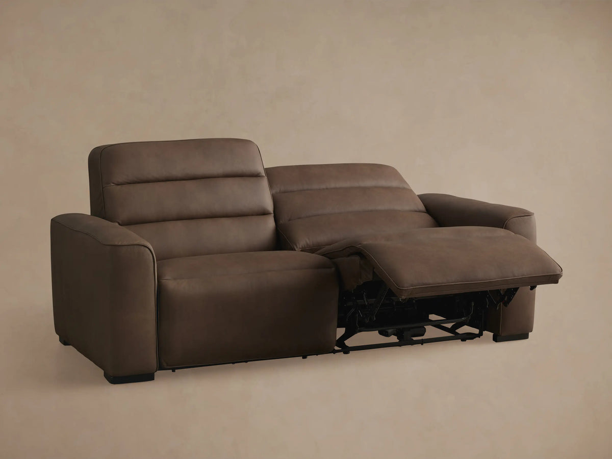 Brown leather Borough Two-Piece Motion Sofa, angled back view against a neutral background.