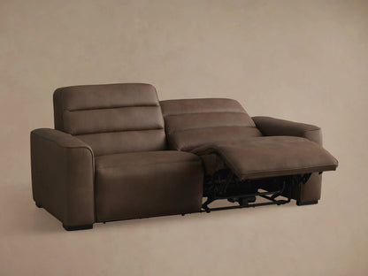 Brown leather Borough Two-Piece Motion Sofa, angled back view against a neutral background.