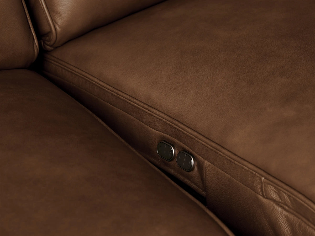 Close-up of a rich brown Borough Leather Motion Sofa armrest & cushion, highlighting soft texture & detailed stitching.