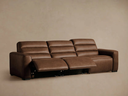 Close-up of a brown leather Borough Motion Sofa, showing neat stitching and two embedded oval-shaped control buttons.