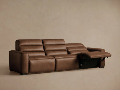 Brown leather three-piece motion sofa with all three footrests extended against a light beige background.