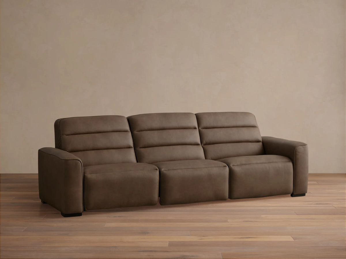 Dark brown Borough Leather Three-Piece Motion Sofa with channel-stitched backrests, viewed frontally in a modern room.