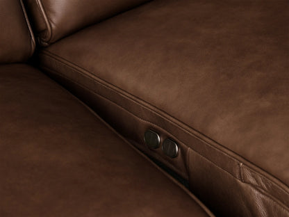 Close-up of the Borough Leather Motion Sectional, showing rich brown leather armrest, cushion, and backrest with fine stitching.