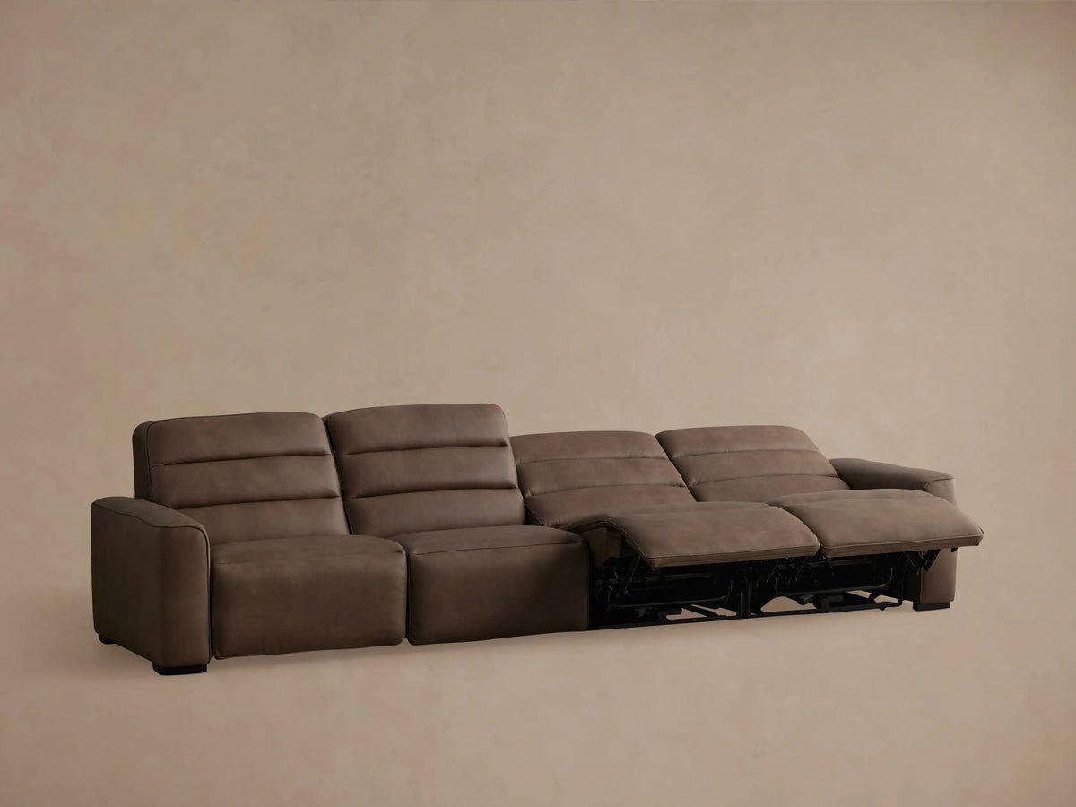 Brown leather Borough Four-Piece Motion Sectional, angled view from the back, showing four modular recliner sections.
