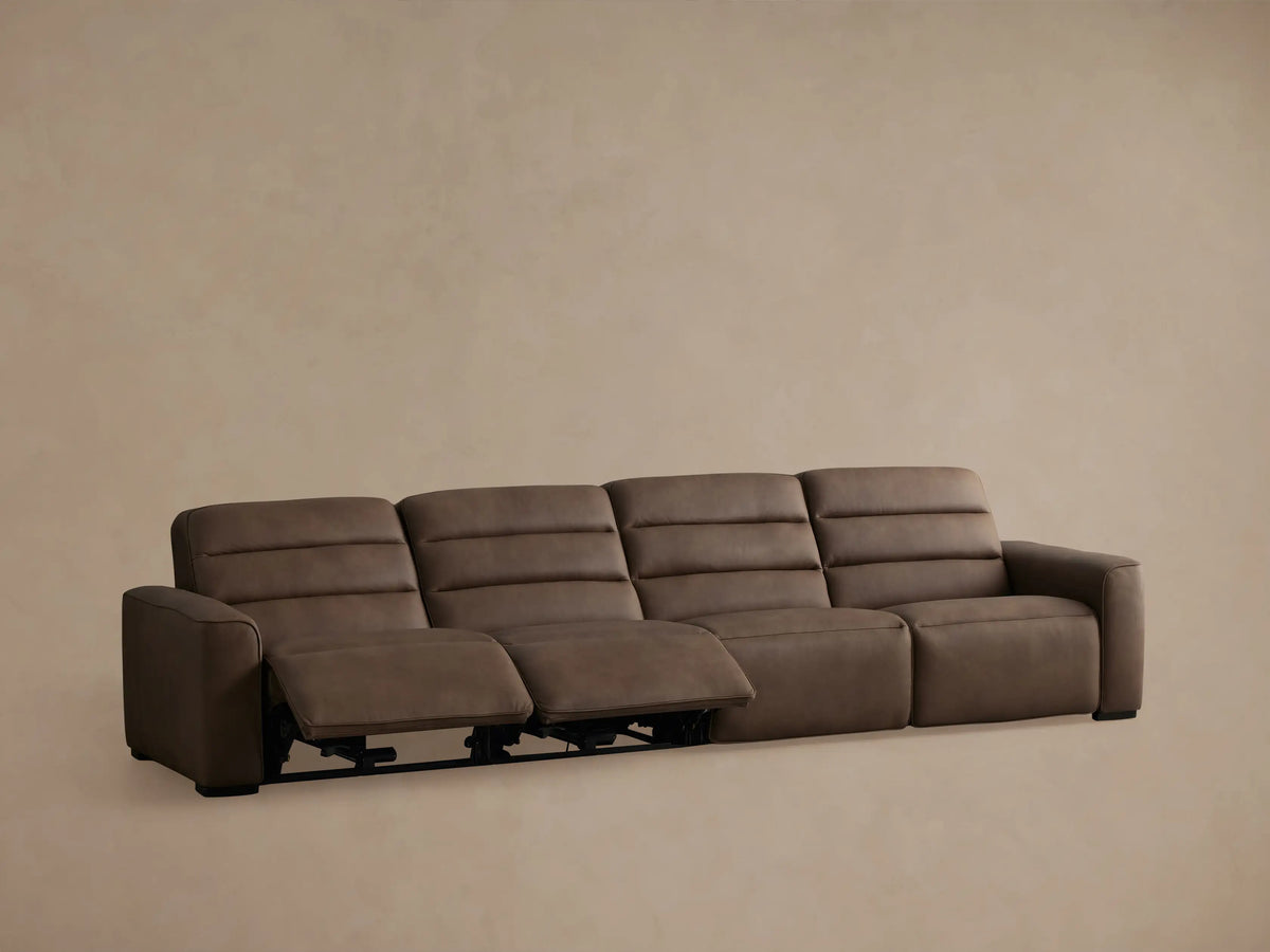 Borough Leather Four-Piece Motion Sectional, brown, with two right seats reclined, footrests extended.