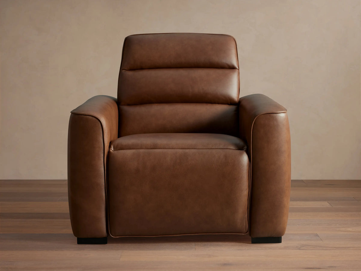 Borough Leather Motion Recliner, rich brown leather, padded back, wide arms, subtle piping, angled right.