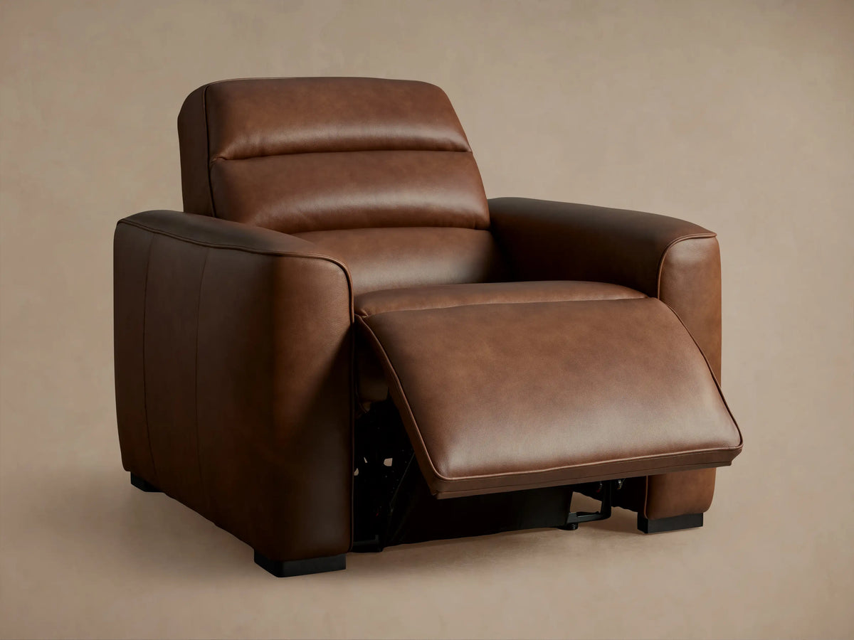 Borough Leather Motion Recliner: angled close-up of extended footrest, revealing rich brown leather texture and black mechanism.