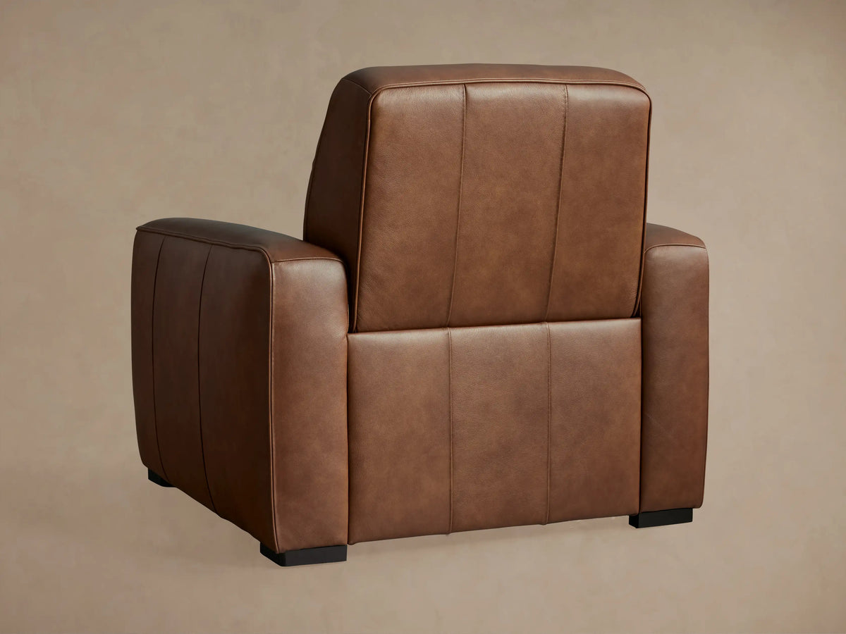 Borough Leather Motion Recliner in rich brown leather, side view, fully reclined with footrest extended, showing black mechanism.