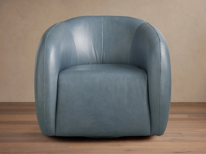 Fresno Leather Swivel Chair in blue-gray leather, featuring a curved, padded backrest and seat on a wooden floor, facing slightly left.