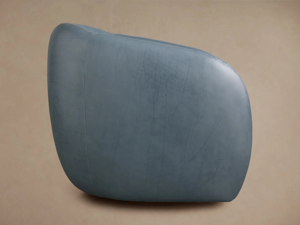 Fresno Leather Swivel Chair in blue leather, featuring a smooth cushioned seat and curved backrest, showcasing its glossy texture.
