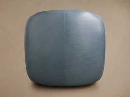 Fresno Leather Swivel Chair in blue leather, viewed from the side. It features smooth, rounded edges and visible stitching.