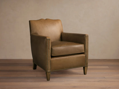Front view of the tan Kinsman Leather Chair with natural-finished nailhead trim and sculpted mustache backrest.
