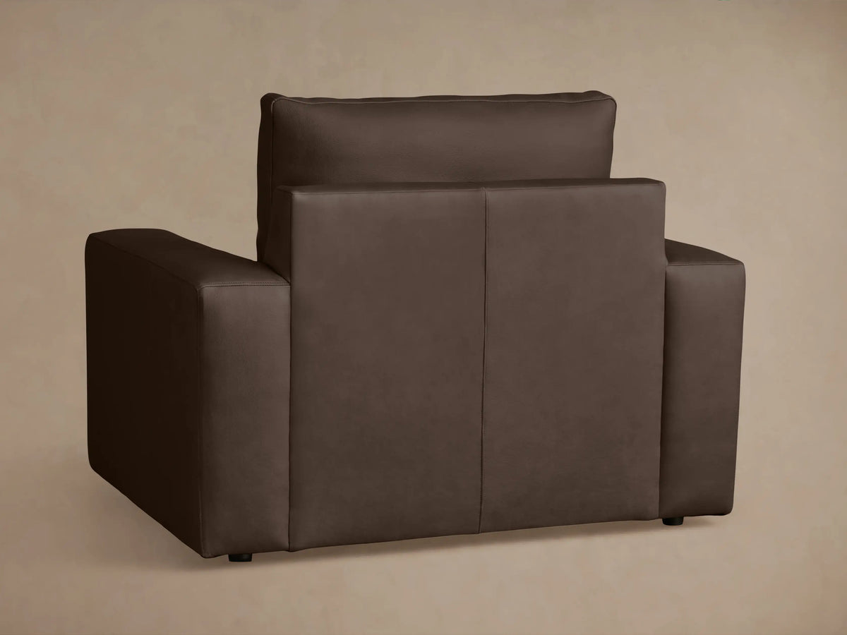 Brown leather Kipton Wide Arm Recliner top view, showing wide armrests, plush seat cushion, and slightly reclined backrest.