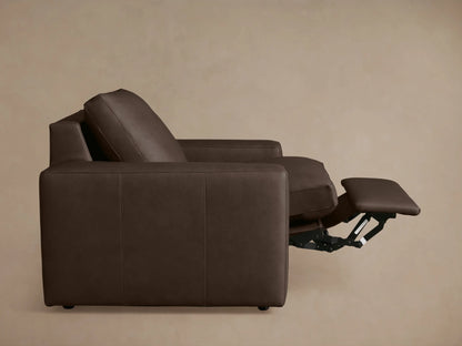 Back view of Kipton Wide Arm Leather Motion Recliner in dark brown leather, featuring wide arms, a tall backrest, and minimalist design.