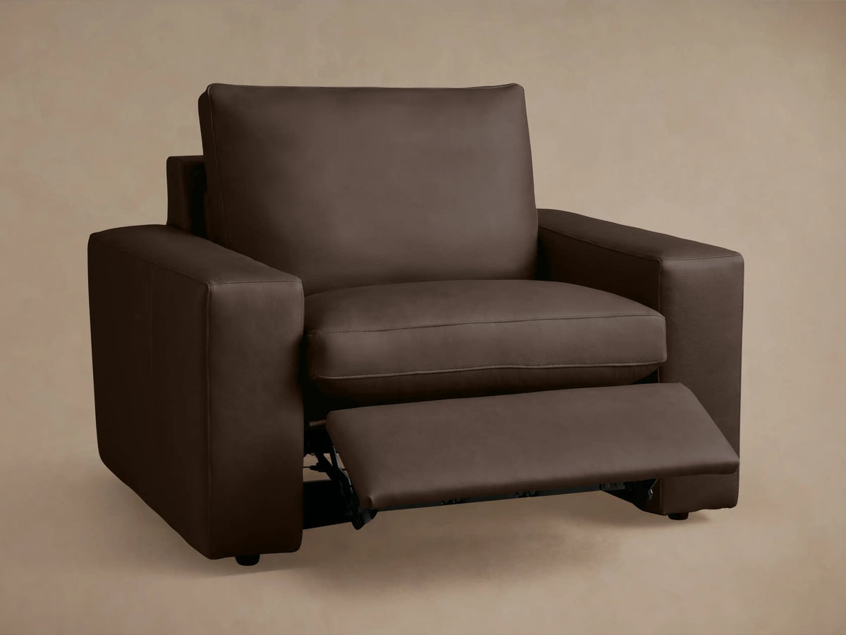 Kipton Wide Arm Leather Motion Recliner in dark brown leather, side view, fully reclined with raised footrest, 8-inch wide armrest.