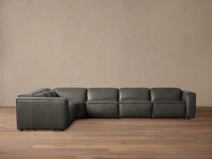 Dark gray leather Coburn Six Piece Motion Sectional, L-shaped, on a wood floor against a neutral wall.