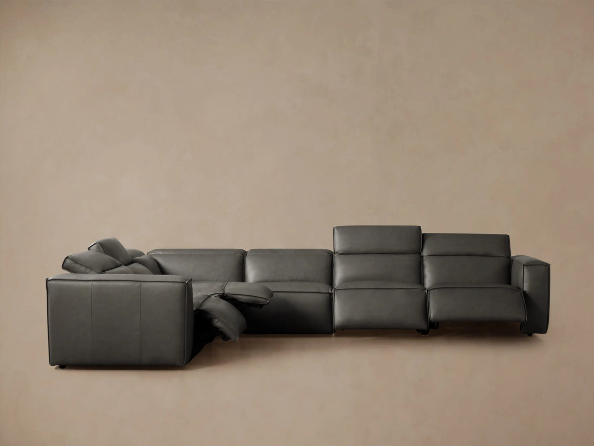 Dark gray leather Coburn Six Piece Motion Sectional, L-shaped, viewed from the back-right, showing padded individual sections.