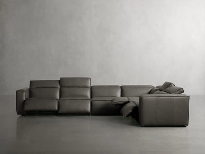 Close-up of Coburn Leather Six Piece Motion Sectional's dark gray leather armrest and cushions, highlighting fine stitching.
