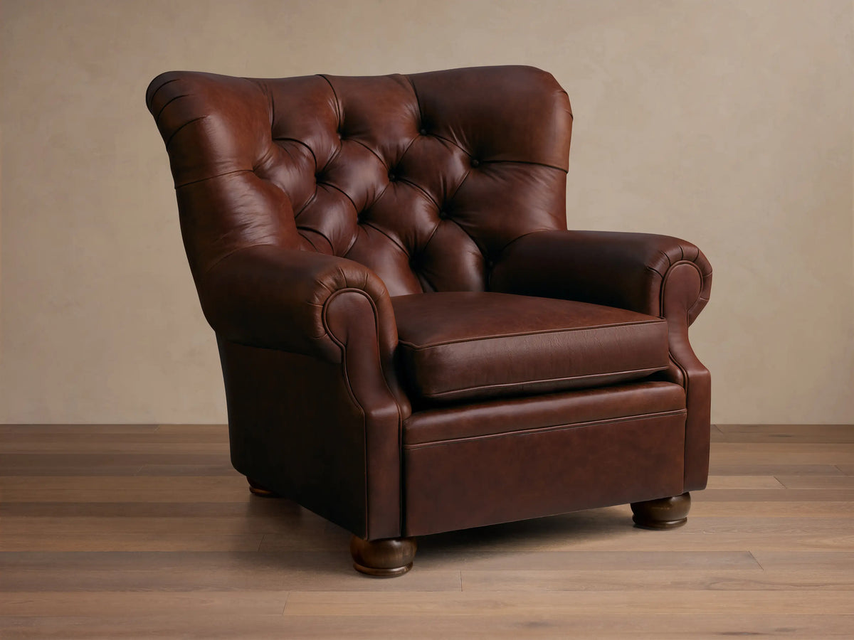 Front view of a brown tufted leather armchair with rolled arms and a single seat cushion.