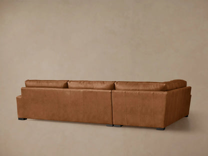 Angled close-up of a warm brown Remington Leather Two-Piece Sectional, highlighting its soft, inviting seat and back cushions.